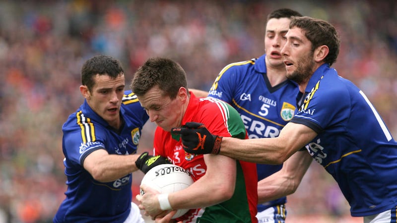 Kerry&#39;s Shane Enright, Paul Murphy and Killian Young try to dispossess Mayo&#39;s Cillian O&#39;Connor in the All-Ireland SFC 