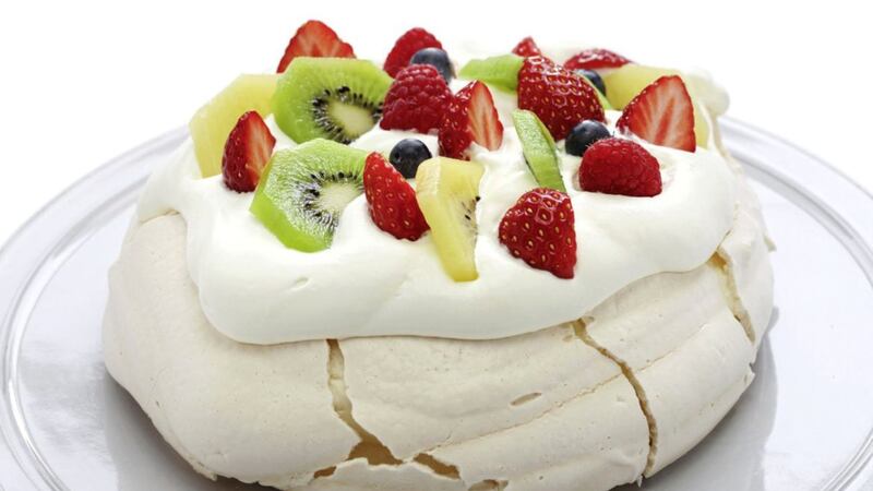A pavlova topped with fruit and dripping with cream is hard to resist. Photo: PA 