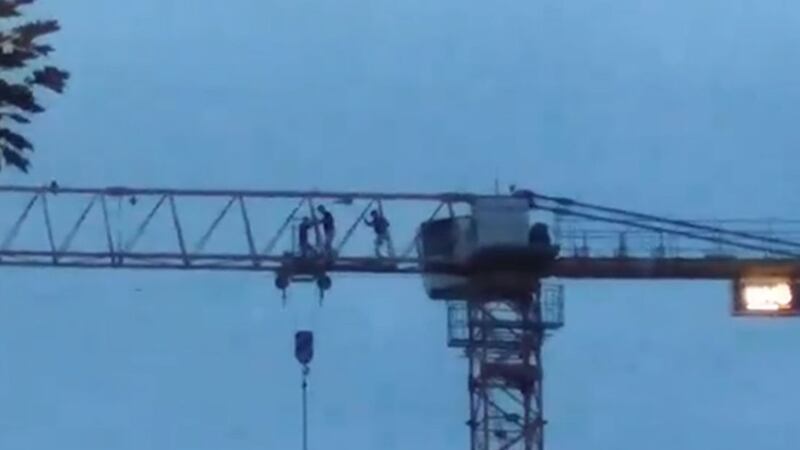 Three people were seen climbing a 100ft crane in Derry at the weekend. Picture from Facebook