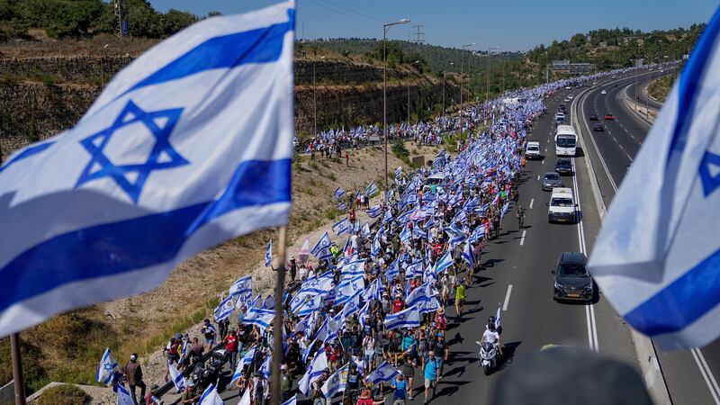 Thousands of Israelis march along a highway towards Jerusalem at the end of their 70-kilometer (roughly 45-mile) march from Tel Aviv (Ohad Zwigenberg/AP)