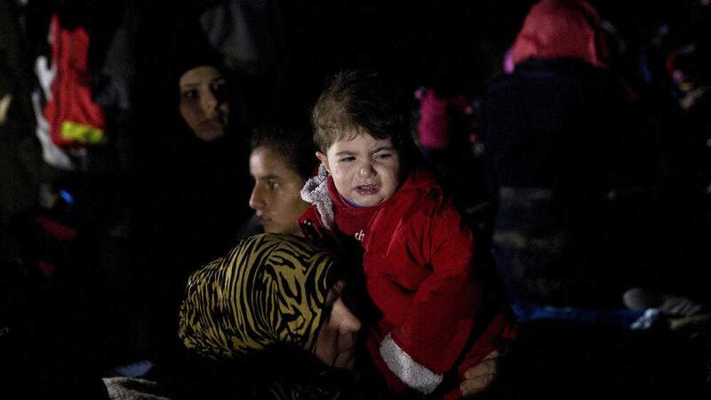 A child cries as she and her family arrived in the northeastern Greek island of Lesbos, after crossing the Aegean sea from Turkey. Picture by Petros Giannakouris, Associated Press