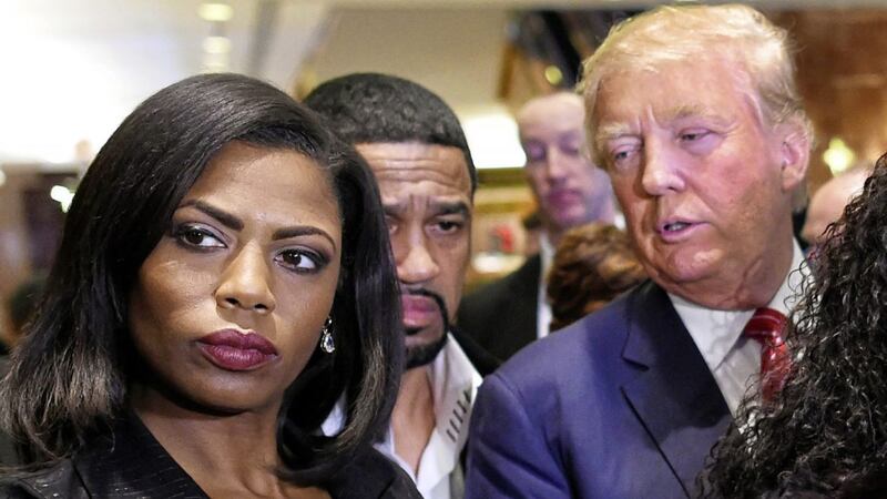 Omarosa Manigault, who was a contestant on the first season of Donald Trump's 'The Apprentice' appears alongside the president in 2015. Picture by Timothy A Clary/AFP/Getty Images)