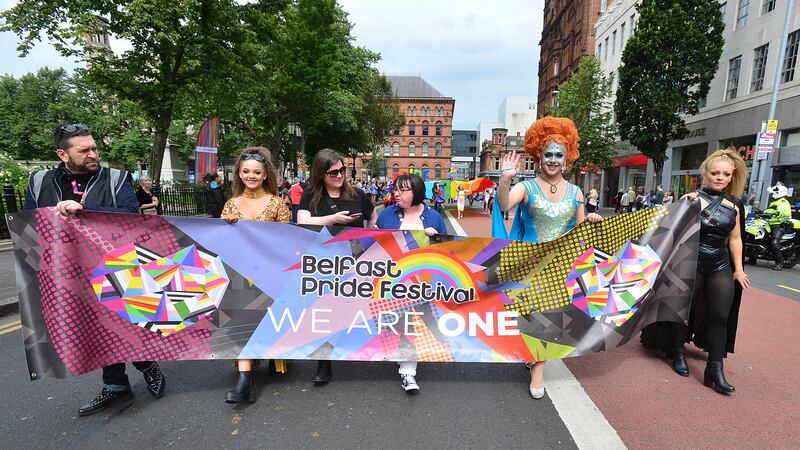 Belfast's first openly gay deputy lord mayor, Sinn Fein's Mary Ellen Campbell, centre, leads the Pride parade as it makes its way through the city