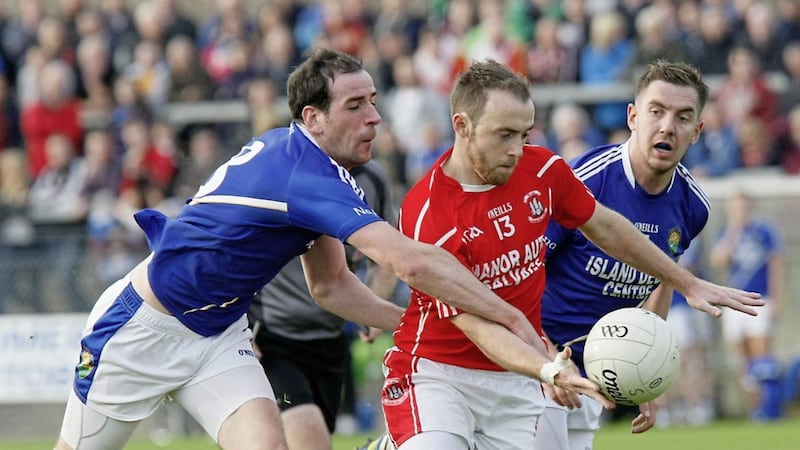 Niall Gormley is closed down by Coalisland&#39;s Plunkett Kane and Louis O&#39;Neill 
