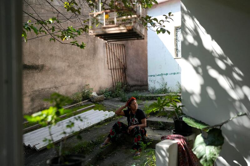 Luakam Anambe, of Brazil’s Anambe indigenous group, who is at the helm of a small, burgeoning business selling handmade indigenous dolls, takes a break outside her home in Rio de Janeiro, Brazil