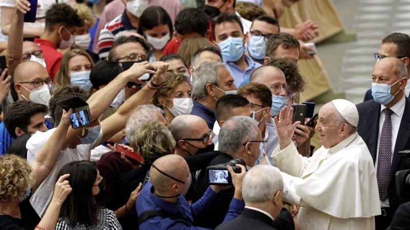 In an example of the &#39;communion&#39; formed by the connection between believers, Pope Francis greets the faithful at the end of one of his weekly general audiences in the Paul VI hall at the Vatican this summer. Picture by AP Photo/Riccardo De Luca 