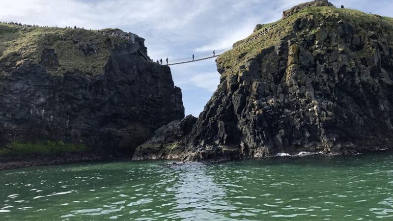 Looking up at Carrick-a-Rede Rope Bridge from our sea safari boat 