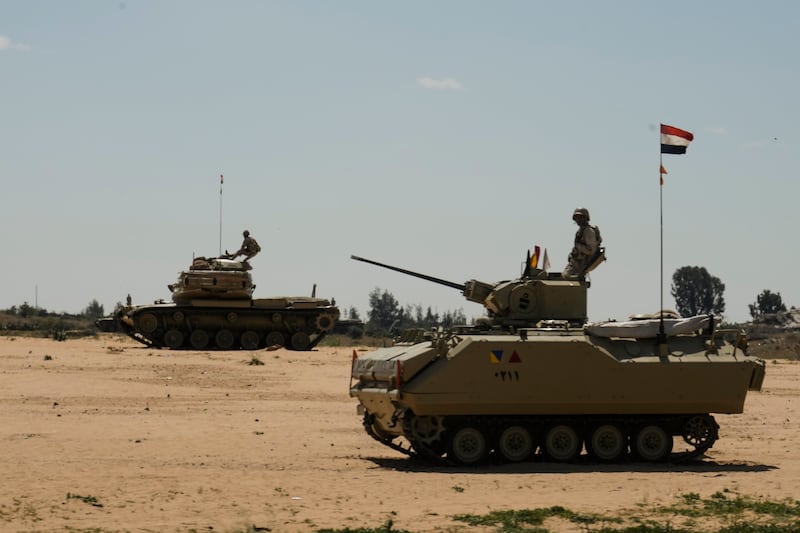Egyptian armoured vehicles near the Rafah border crossing (AP)