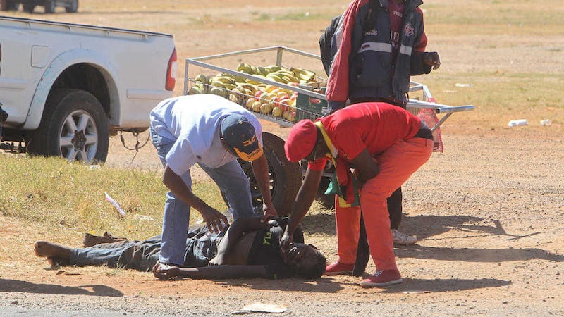 A suspected protestor lies on the ground unconscious after a confrontation with Zimbabwean riot police during a demonstration in Harare PICTURE: Tsvangirayi Mukwazhi/AP 