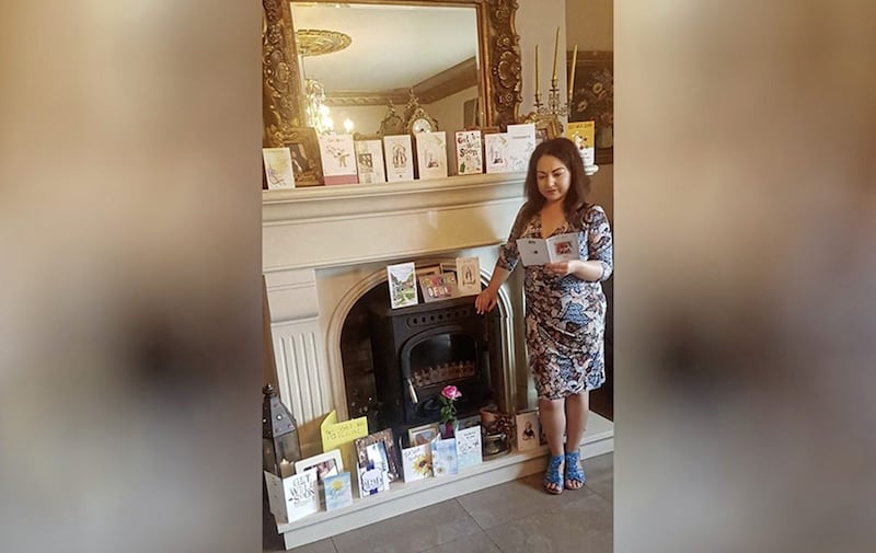 Rachel Morgan reading one of many cards from well-wishers following a sectarian attack on her husband Paschal in Kilkeel, Co Down 