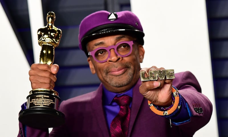 Spike Lee holds up his Oscar for Best Adapted Screenplay