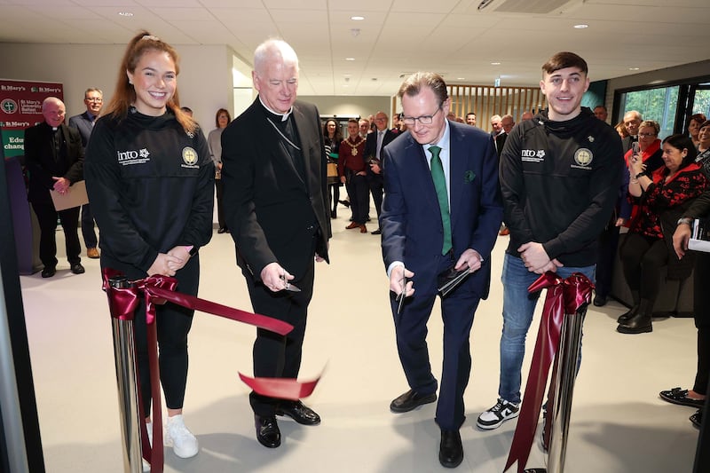 St Mary's students Shanna Cassidy and Niall Burns along with Archbishop Noel Treanor and Ian Greer, QUB vice-chancellor. Picture by Mal McCann