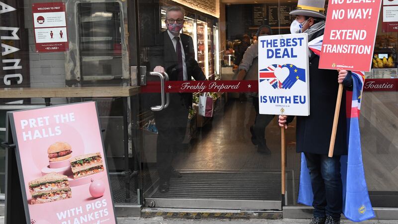&nbsp;The Chancellor of the Duchy of Lancaster, Michael Gove, collects his morning coffee from a coffee shop in central London, whilst an anti-Brexit protester waits for him outside (right) as talks to strike a post-Brexit trade deal continue.