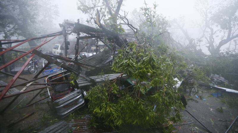 A tricycle is pinned by tree branches at the height of Super Typhoon Haima that lashes Narvacan township, Ilocos Sur province Philippines yesterday Thursday. Picture by Bullit Marquez, Associated Press 