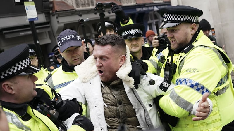 Tommy Robinson is led away by police as people take part in a march against antisemitism (Jordan Pettitt/PA)