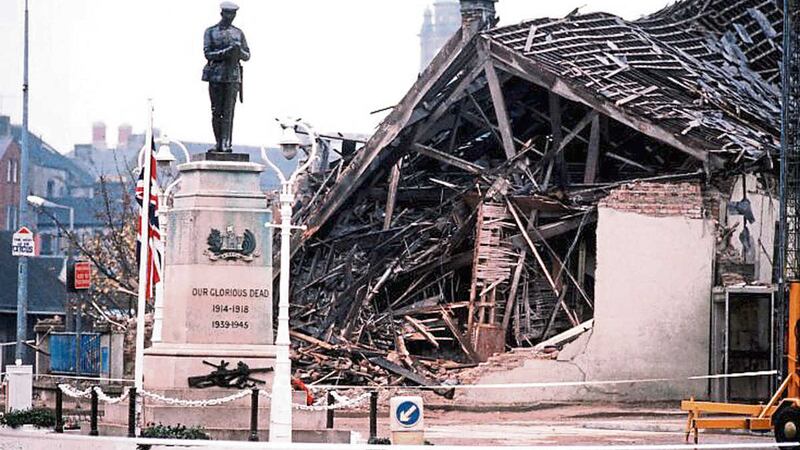 The Cenotaph at Enniskillen with the devastated community centre in the background where 11 people were killed&nbsp;