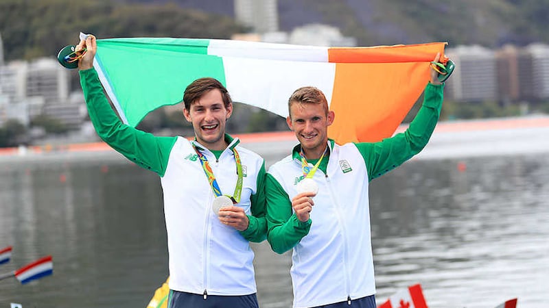 Paul and Gary O'Donovan celebrate with their silver medals<br />Picture by AP&nbsp;