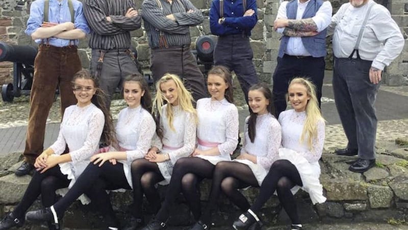 Hounds of Ulster, including Craig Young (far left), with Irish dancers from the McCullough-Curran School at Carrickfergus Castle. File picture from Hounds of Ulster/Facebook 