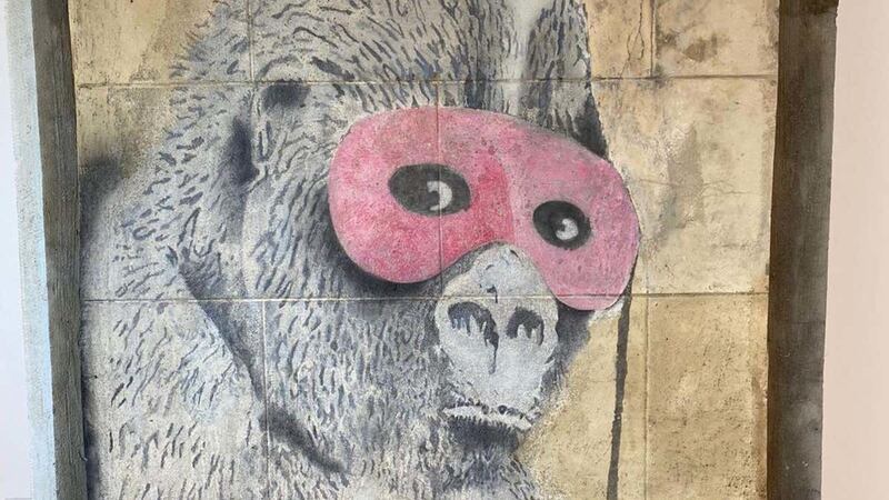 Gorilla In A Pink Mask appeared on a wall in Eastville, Bristol, in 2001 and was painted over in 2011 but has now been removed and restored.