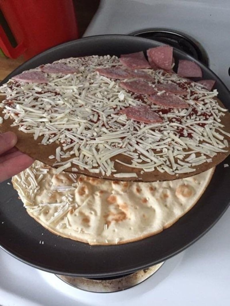The pizza with cardboard in between base and topppings