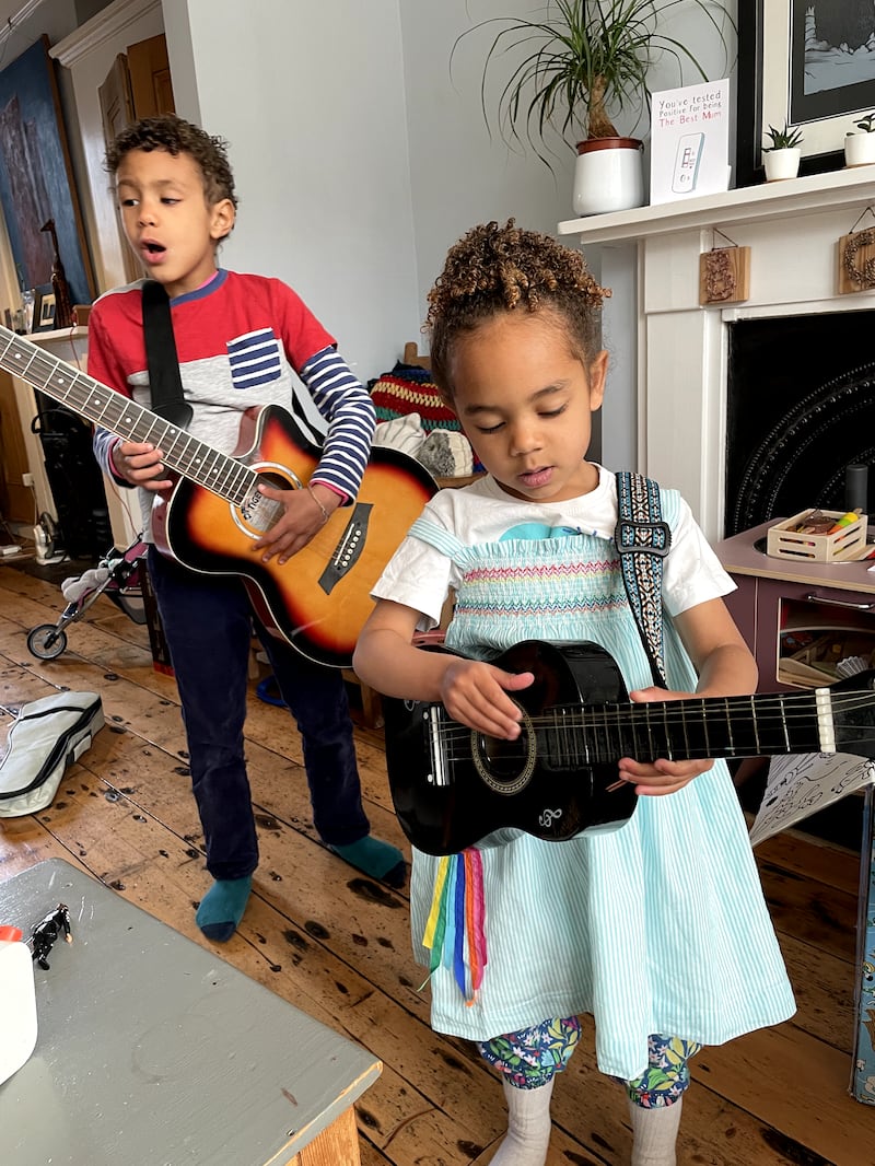 Ravi and his sister Maya practising guitar