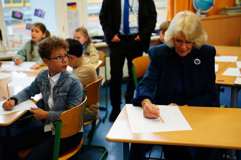 The Queen Consort drawing the Gruffalo, during a visit to Rudolf Ross Grundschule School, Hamburg