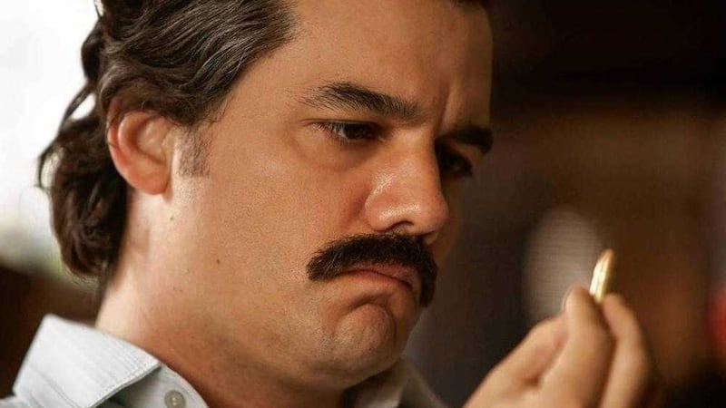 Pablo Escobar (Wagner Moura) checks a bullet for his name in a scene from Narcos 