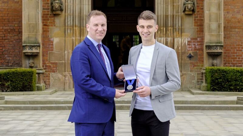 Shea Heffron receives the Cormac McAnallen Medal from Donal McAnallen. Shea is the seventh recipient of the award 