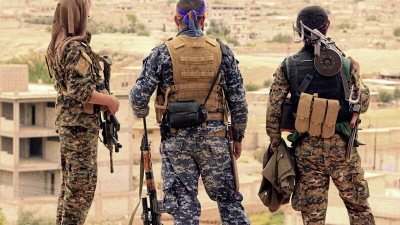 Fighters from the Syrian Democratic Forces, pictured in April, look towards the northern town of Tabqa in Syria Picture;AP 