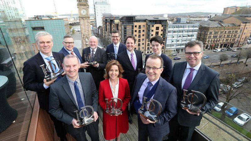 IoD regional chairman Paul Terrington and Richard Ennis of sponsors First Trust Bank with category winners in the IoD NI First Trust Bank Director of the Year Awards. Photo: Kelvin Boyes / Press Eye 