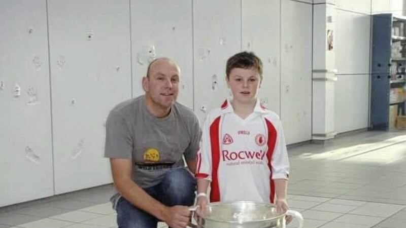 Jarlath and Cian Corrigan with The Sam Maguire Cup, which Tyrone captain and Cian&#39;s GAA hero Peter Canavan had brought into hospital to show to him 