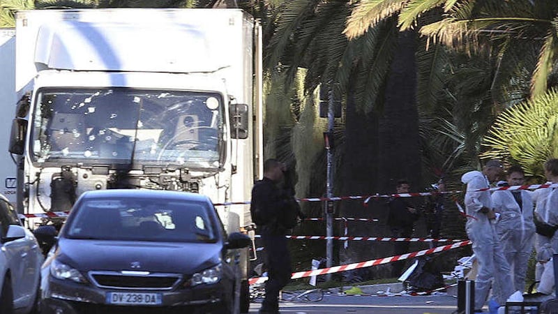 The truck which slammed into revelers late Thursday, July 14, is seen near the site of an attack in the French resort city of Nice, southern France, Friday, July 15, 2016. France has been stunned again as a large white truck mowed through a crowd of revelers gathered for a Bastille Day fireworks display in the Riviera city of Nice. (AP Photo/Luca Bruno 