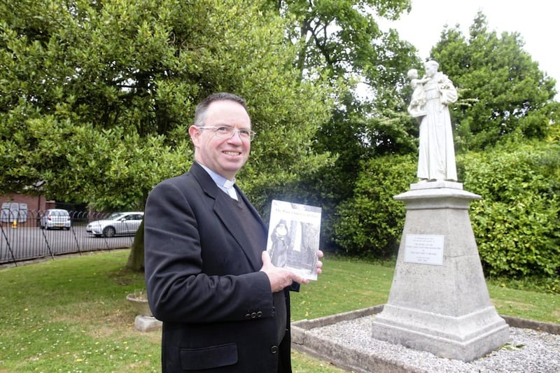 Fr Martin Magill with his book about the story of the Poor Clare community in Belfast. Picture by Mal McCann