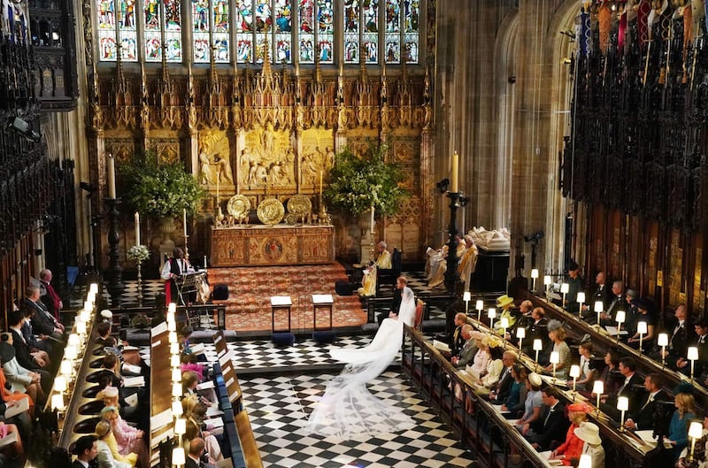 Prince Harry and Meghan Markle listen to an address by the Most Rev Bishop Michael Curry, primate of the Episcopal Church, in St George’s Chapel at Windsor Castle during their wedding service
