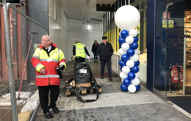 Pedestrians use the temporary walkway that allows them to walk past the Primark building for the first time in three months. Picture by Mal McCann&nbsp;