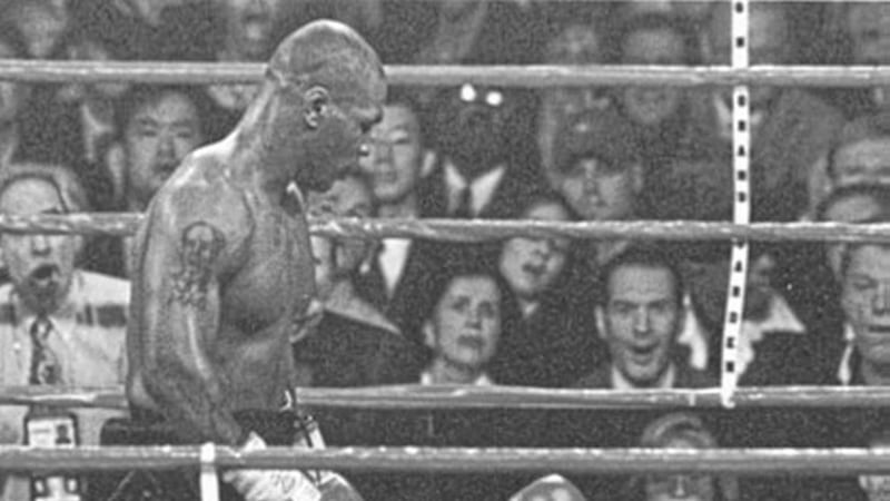 Mike Tyson stands over his stricken opponent, Francois Botha, after flooring him just seconds from the end of the fifth round to end the heavyweight fight in Las Vegas 