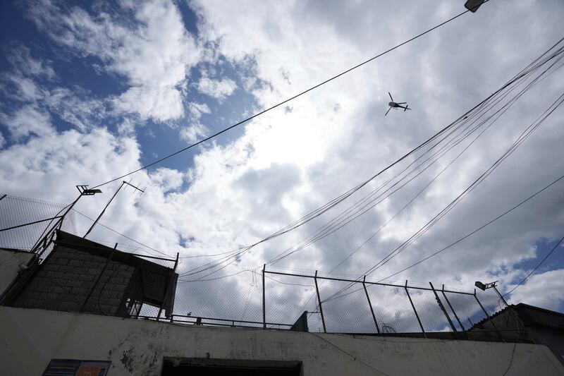 A helicopter flies over El Inca prison (Dolores Ochoa/AP)