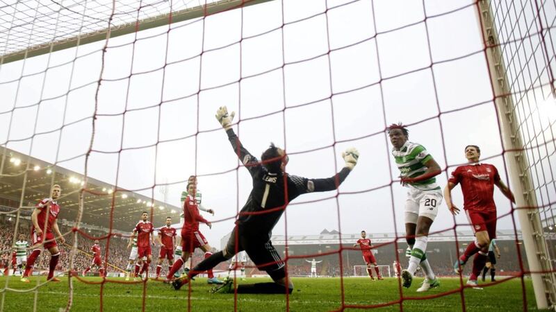 some boy: Dedryck Boyata nods home Celtic&rsquo;s first goal in the 3-1 victory over Aberdeen on Friday. The Belgian defender believes the Hoops underlined their desire to stay unbeaten all season by grinding out a win at Pittodrie										             Picture: PA 