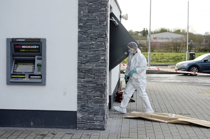 A forensic officer at the scene of an attempted ATM robbery in Toome. Picture by Mark Marlow