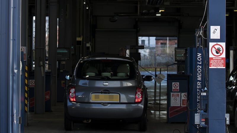 A headlight beam test is carried out on a vehicle during its MOT test (PA)