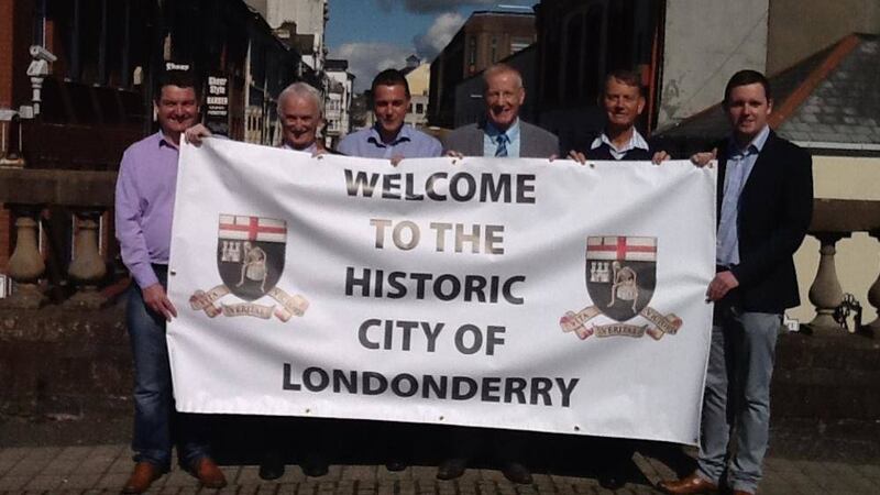 MLAs Gregory Campbell and Gary Middleton along with DUP councillors pictured with the party&#39;s new Derry name-change banner.  