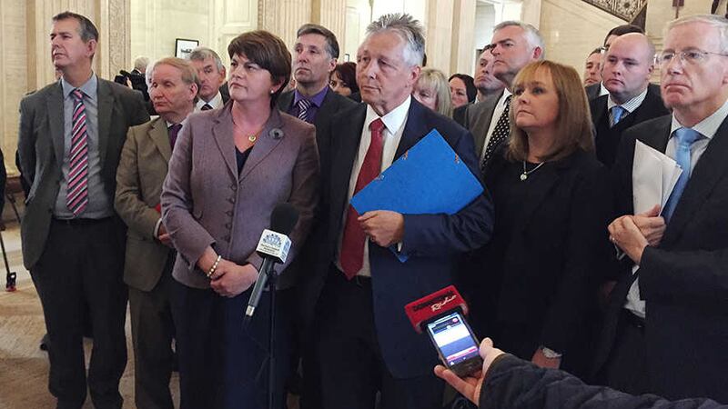 First Minister Peter Robinson (centre) at Stormont surrounded by DUP colleagues as he announced there will be no further routine meetings of the powersharing Executive until the political crisis is resolved&nbsp;