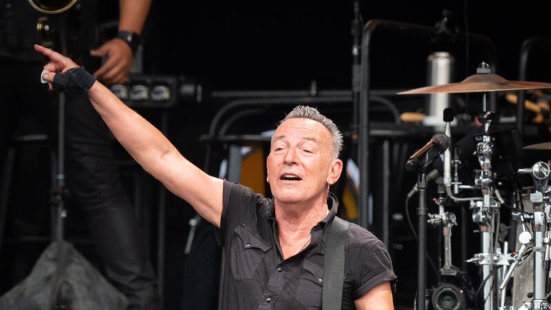 Bruce Springsteen and the E Street Band performing on stage
