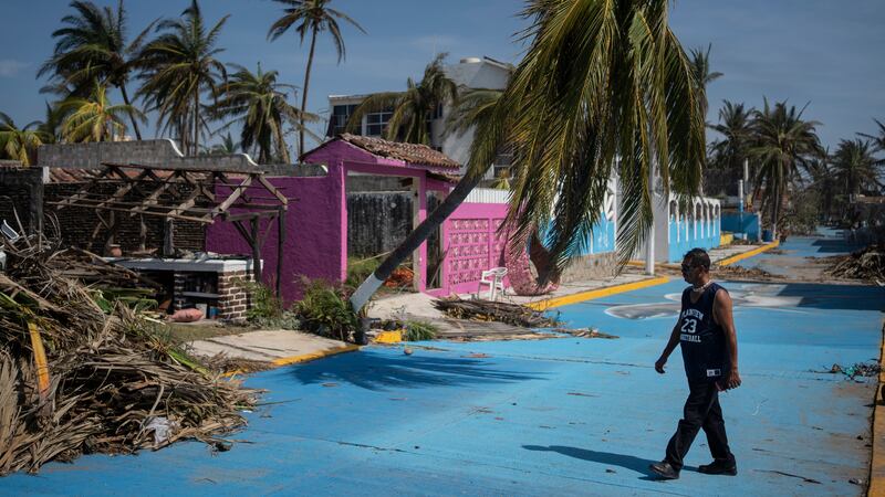 A man walks past damage from Hurricane Otis in Acapulco, Mexico, on Sunday (Felix Marquez/AP)