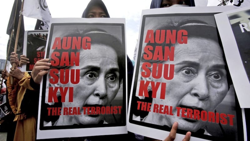 Muslim women hold posters of Myanmar&#39;s State Counsellor Aung San Suu Kyi during a rally against the persecution of Rohingya Muslims in Medan, North Sumatra, Indonesia, on Wednesday. Picture by Binsar Bakkara, Associated Press 
