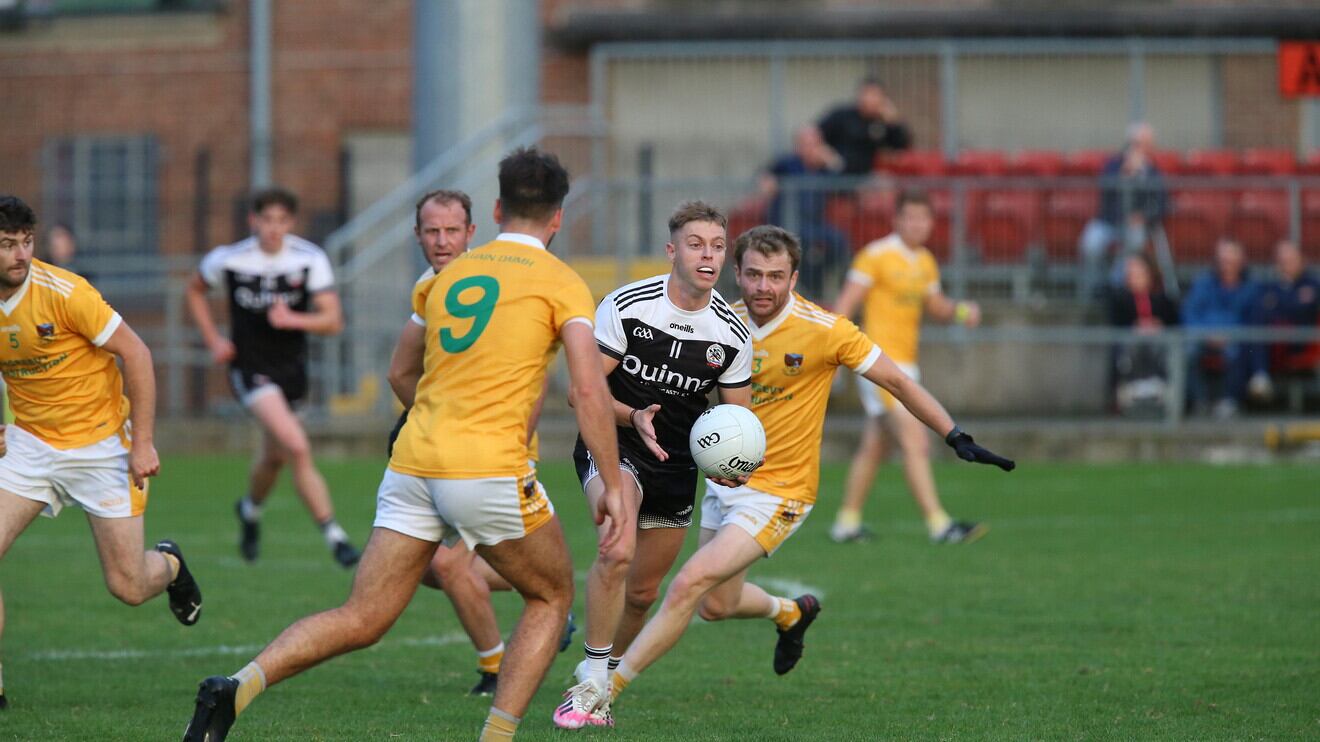 Kilcoo's Jerome Johnston tries to get past Clonduff's Ruairí Lively and Patrick Brown during the Down SFC first round match at Páirc Esler on Friday night   Picture: Louis McNally