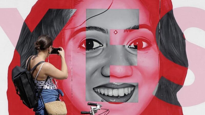 A woman photographs a mural of Savita Halappanavar in Dublin. Picture by Niall Carson/PA Wire 
