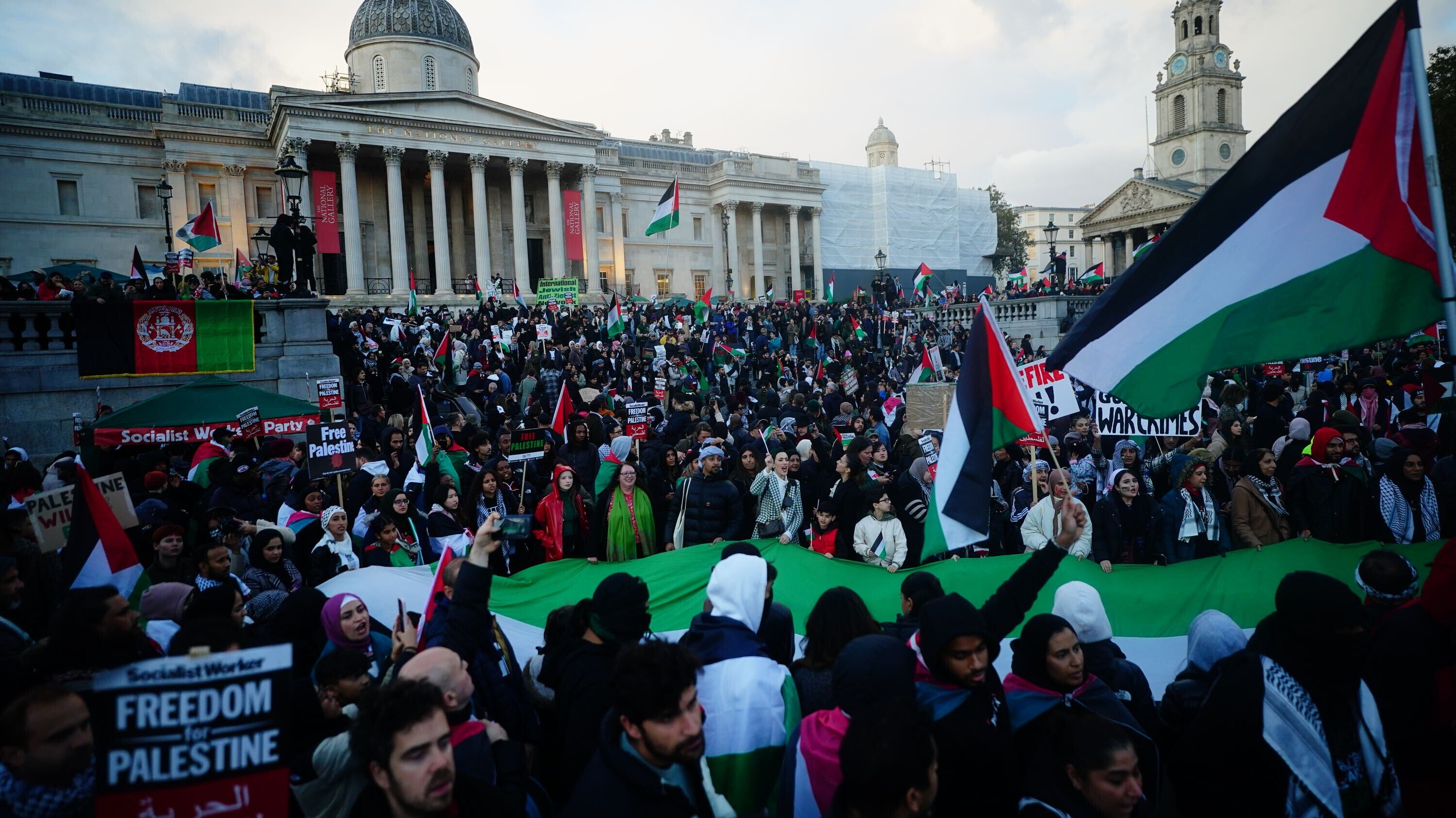 People at a rally in Trafalgar Square, London, during Stop the War coalition’s call for a Palestine ceasefire (Victoria Jones/PA)