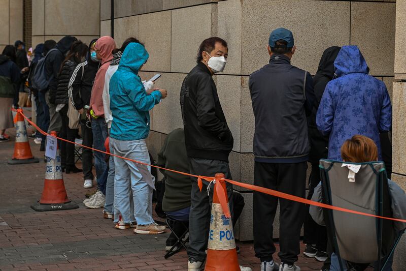 Members of the public queue to enter West Kowloon Magistrates’ Courts, where activist publisher Jimmy Lai’s trial is taking place (Billy HC Kwok/AP)