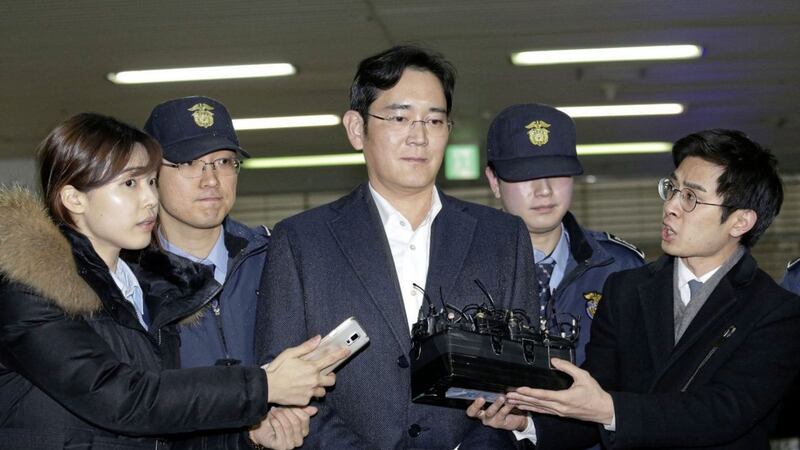 Lee Jae-yong, center, vice chairman of Samsung Electronics Co, has been indicted on on bribery, embezzlement and other charges. Picture by Ahn Young-joon, Associated Press 